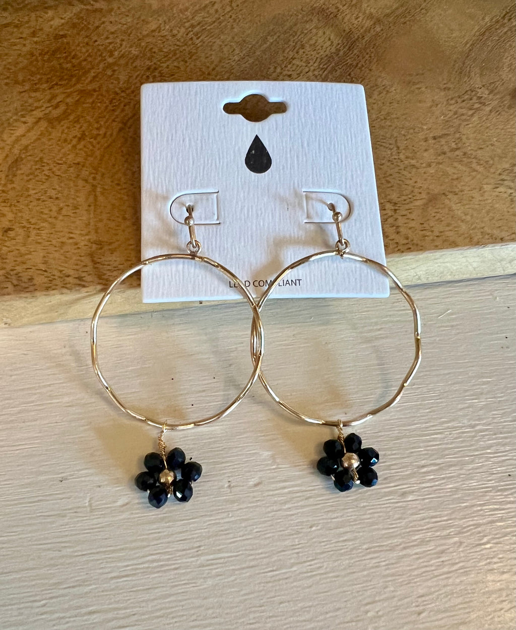 Gold Circle Earring with Black Flower